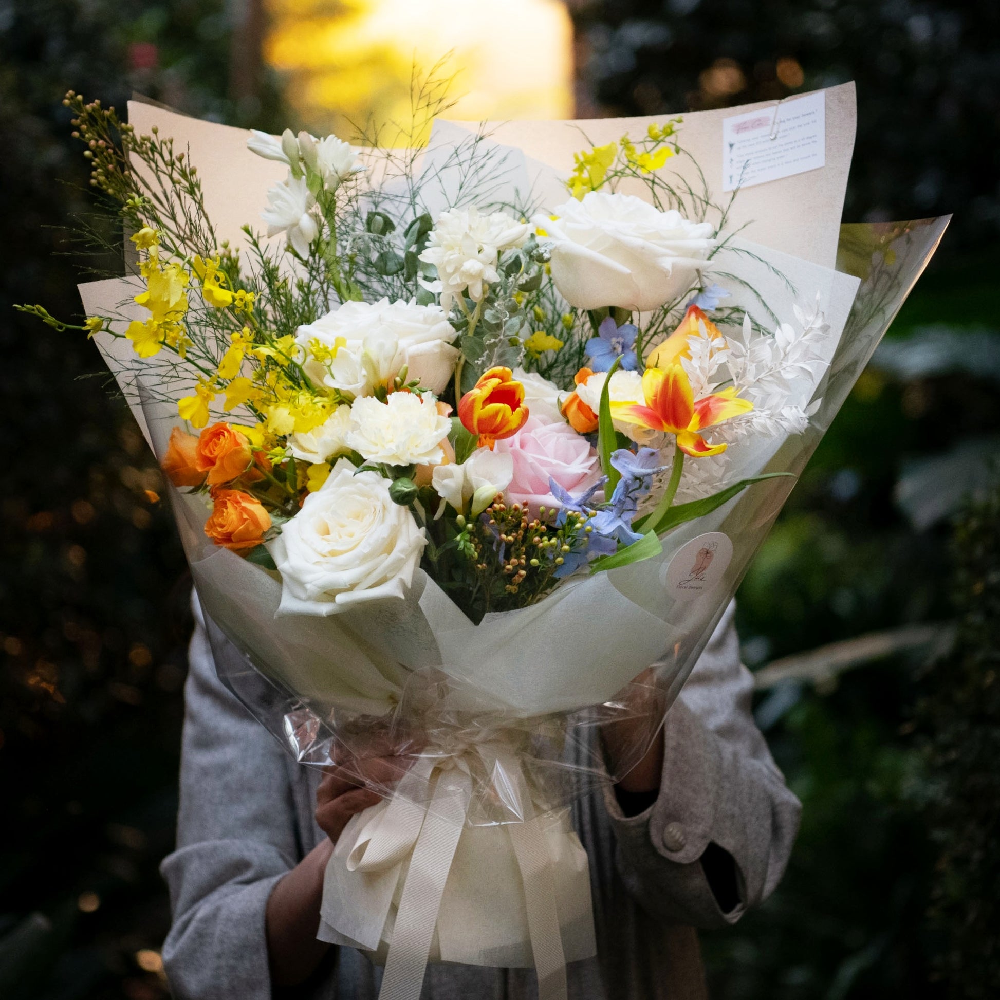 In orange or yellow hue, tulip, rose, lady dancing orchid, freesia, delphinium