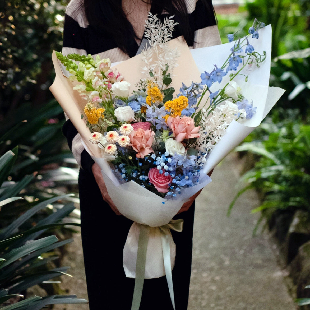 In blue hue, delphinium, rose, snap dragon, buddleja, button Chrysanthemum